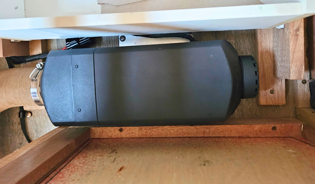 Diesel Heater unit in position next to a drawer and cupboard wall.